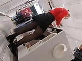 Candid lady in black pantyhose working in a store